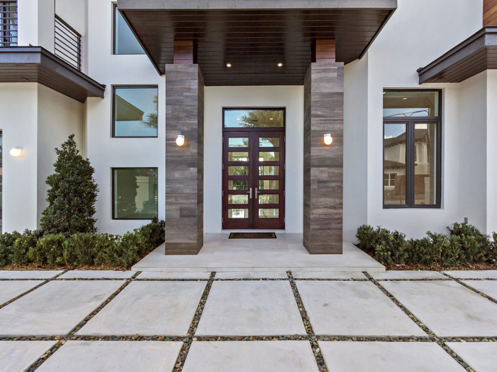 Double glass impact front entry doors on a modern home