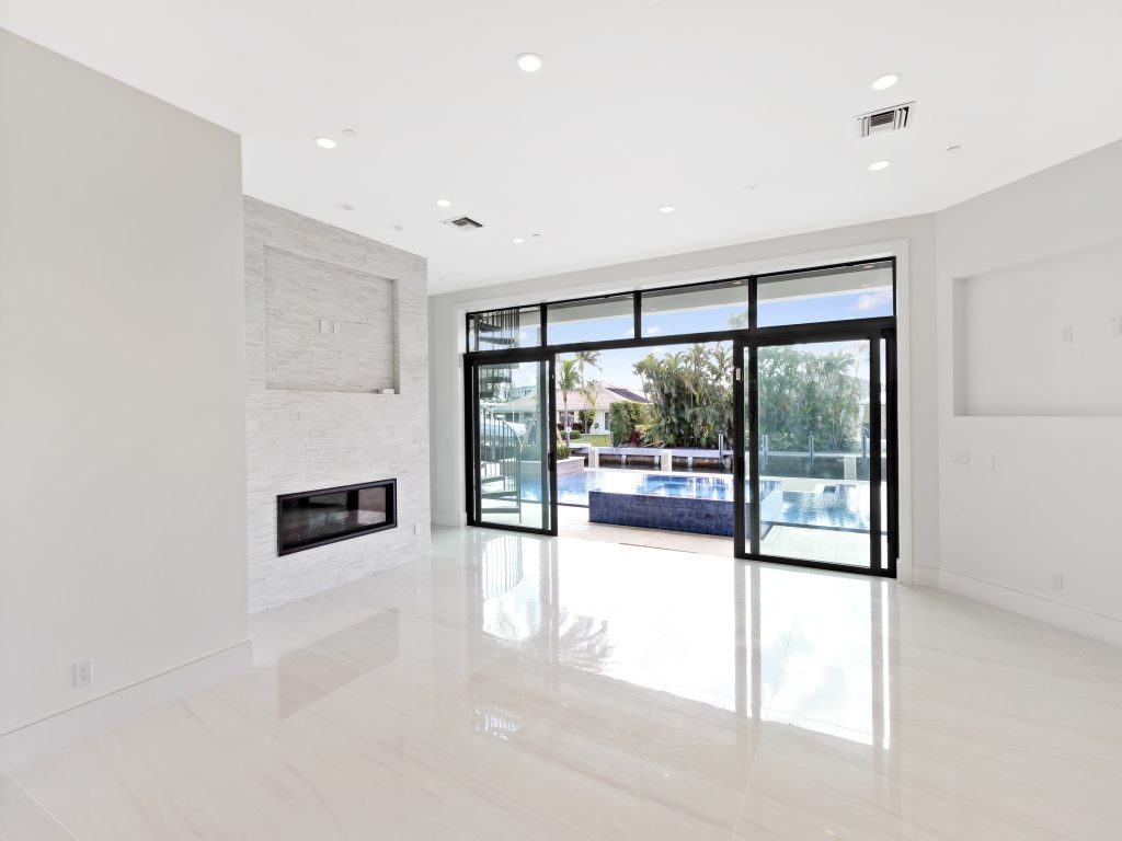 Impact sliding glass doors opening to a pool deck